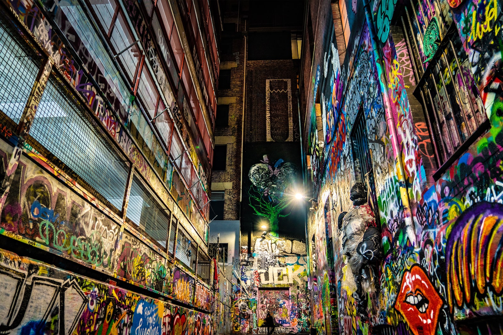 Colourful graffiti lanes facing a brick wall in Hosier Lane